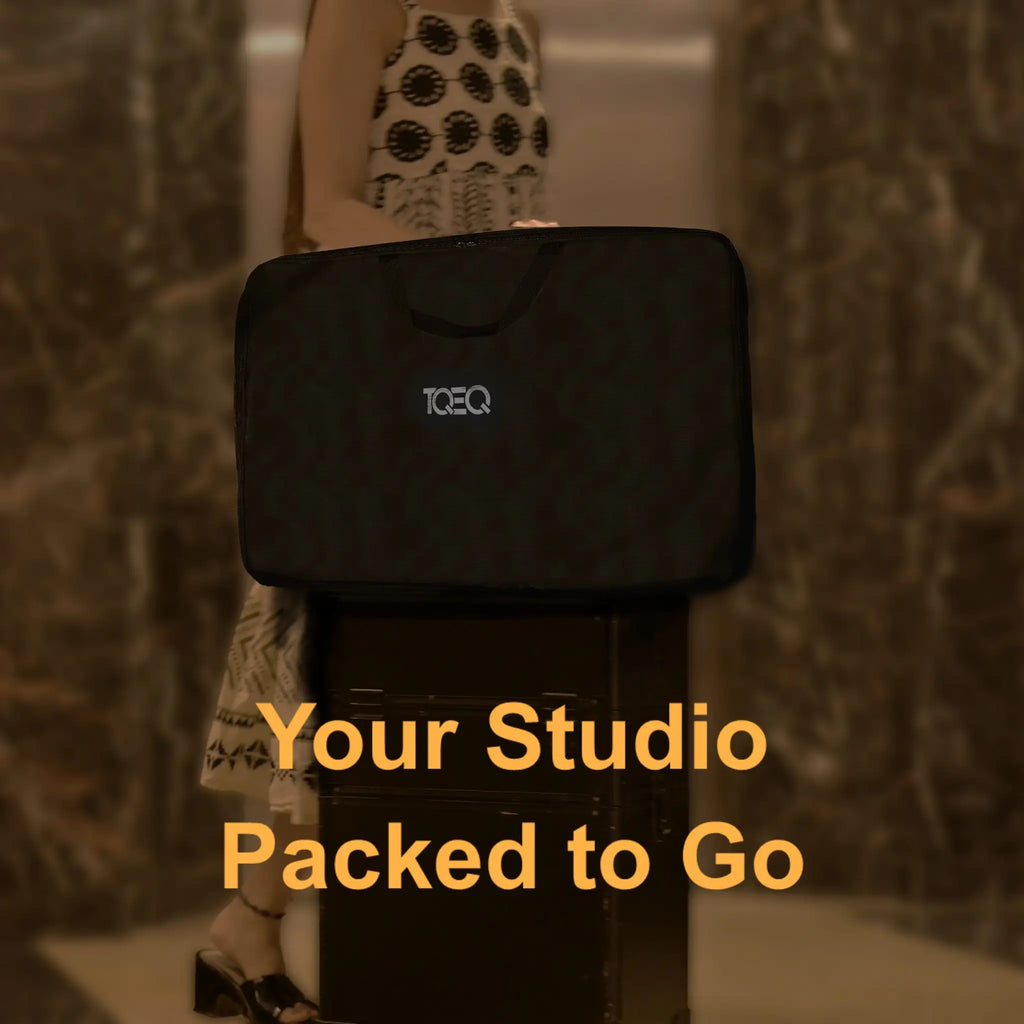 Complete Studio in single Carry bag with 'TOEQ' branding on a makeup trolley carried by Makeup Artist (MUA) traveling against a textured wall.
