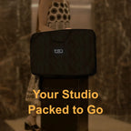 Complete Studio in single Carry bag with 'TOEQ' branding on a makeup trolley carried by Makeup Artist (MUA) traveling against a textured wall.